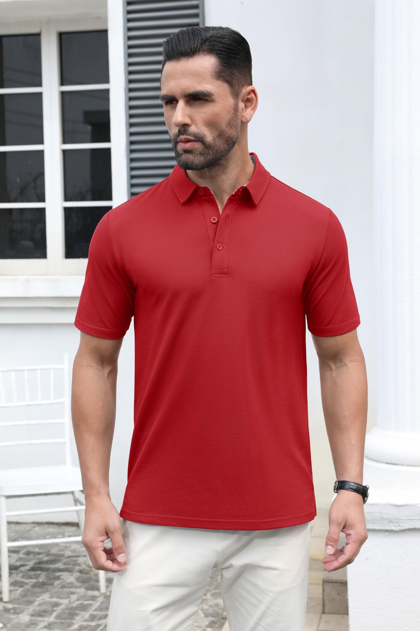 Man wearing a red polo shirt standing