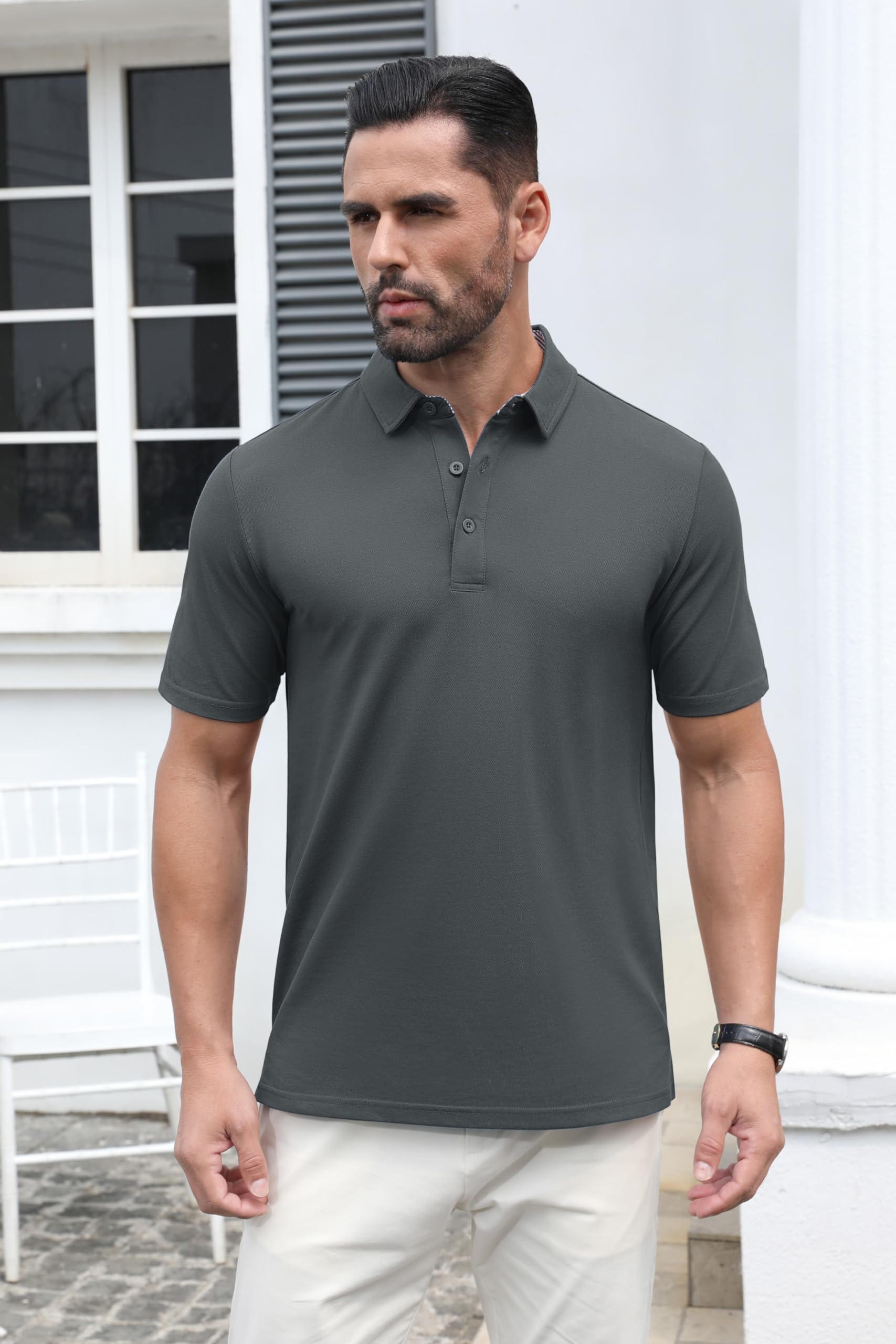 Man wearing a dark gray polo shirt and light-colored 